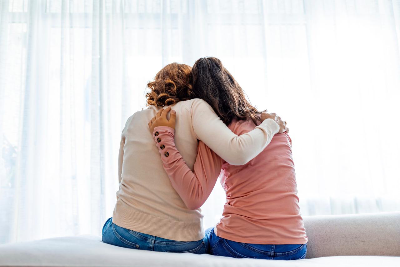 Two friends hugging, showing support and connection